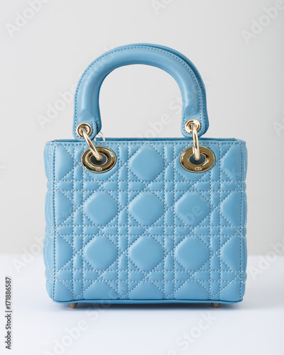 The blue bag with short handle