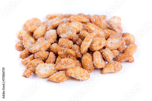 Pile of sweet roasted peanuts isolated on a white background