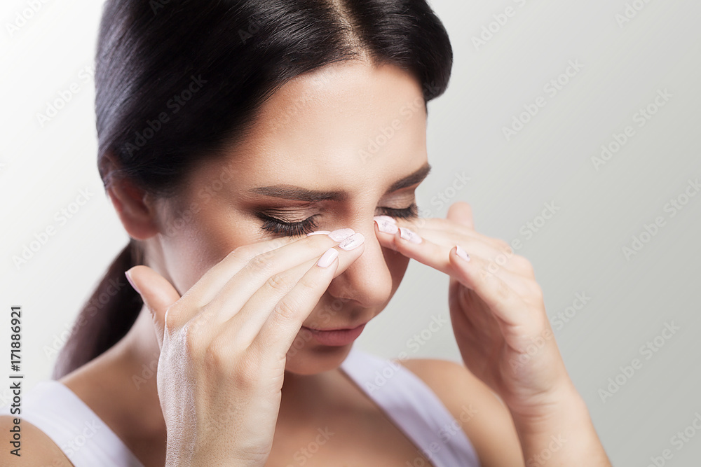 Unhappy, frustrated girl. Bullish appearance. Wonders of migraine or headache. After serious stress. The concept of health. Beautiful young woman.