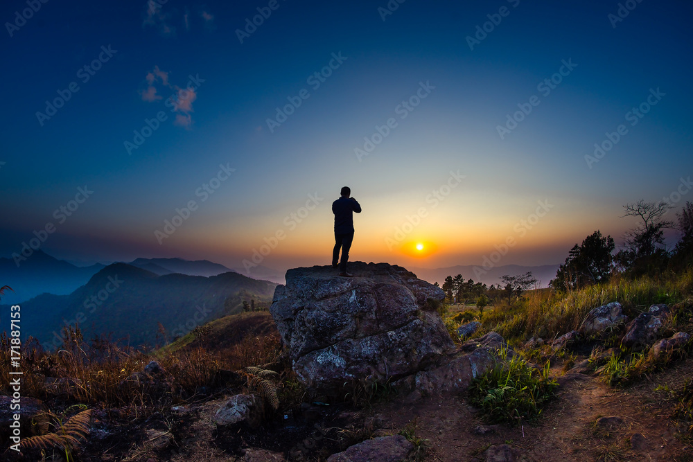 Man with silhouettes while sunrise