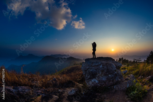 Women with camera silhouettes while sunrise