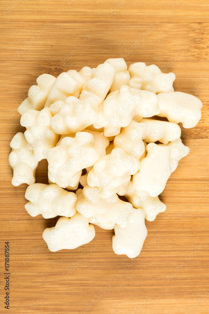Pile of vanilla cream jelly bears on a wood background Pile of vanilla cream jelly bears on a wood background