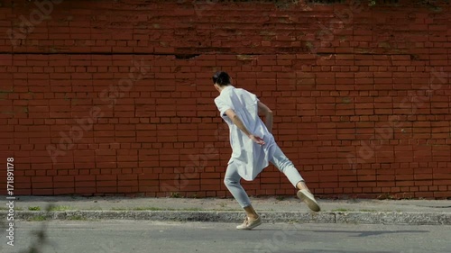 Wallpaper Mural Modern ballet dancer. The young beautiful dark woman rotating around herself dancing in the street. Slow motion. HD Torontodigital.ca