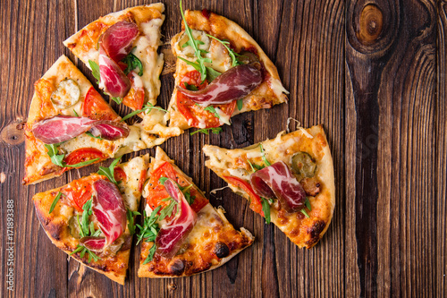 Wallpaper Mural Homemade pizza with tomatoes, cheese, meat and herbs. Pizza on a wooden background. Restaurant meal. Copy space. Torontodigital.ca