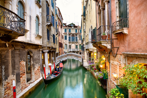Traditional canal street with gondola in Venice, Italy Fototapeta