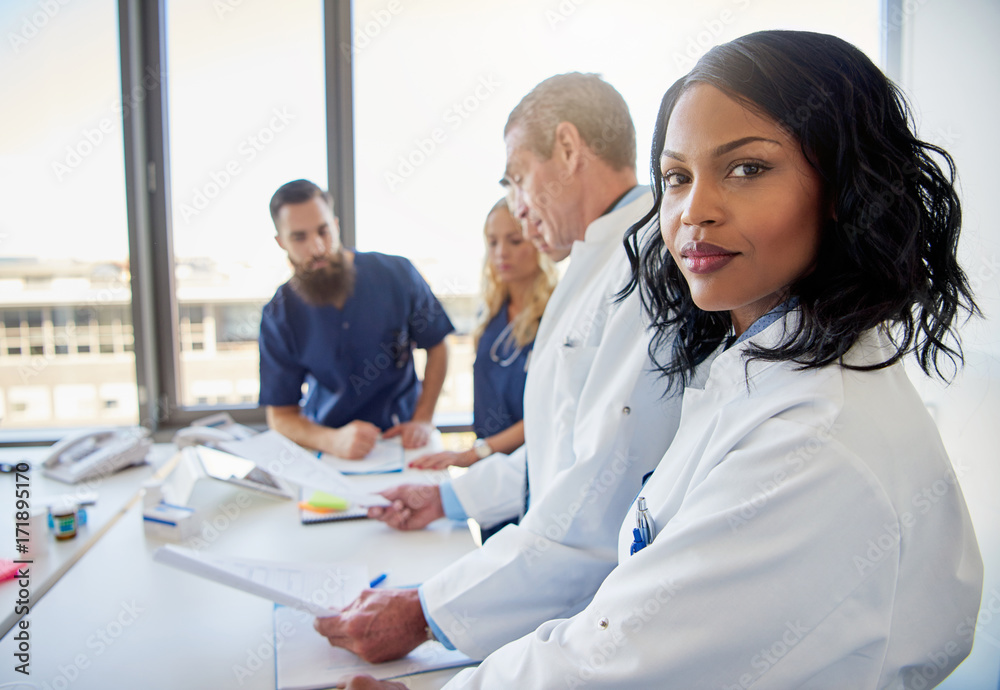 Black female doctor looking at camera in clinic