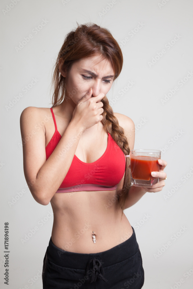 Beautiful healthy Asian girl hate tomato juice. Beautiful healthy Asian girl hate tomato juice.