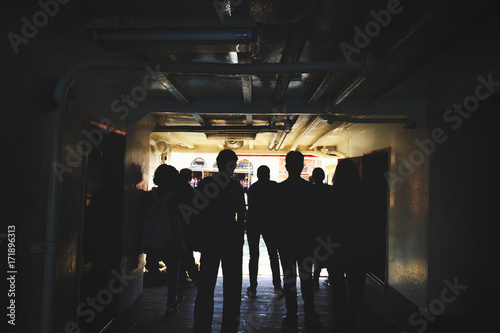 Silhouette of anonymous people waiting for deboard from the ship photo