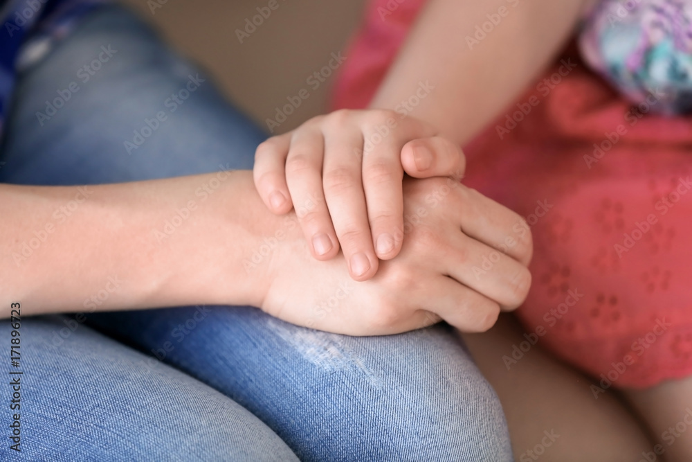 Mother and daughter holding hands together, closeup Mother and daughter holding hands together, closeup