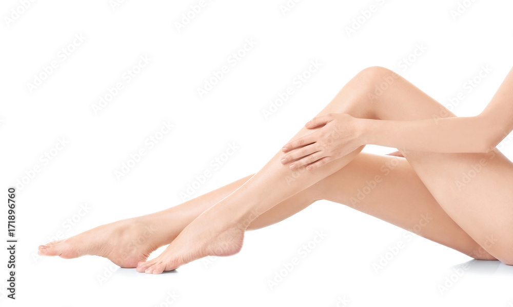 Young woman touching her leg on white background Young woman touching her leg on white background