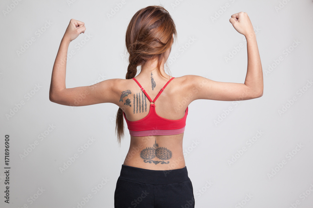 Back of Asian  healthy  girl  in sport dresses flex bicep.