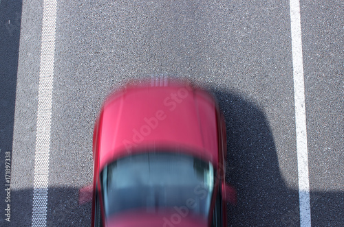 Fragment of the road with a moving car