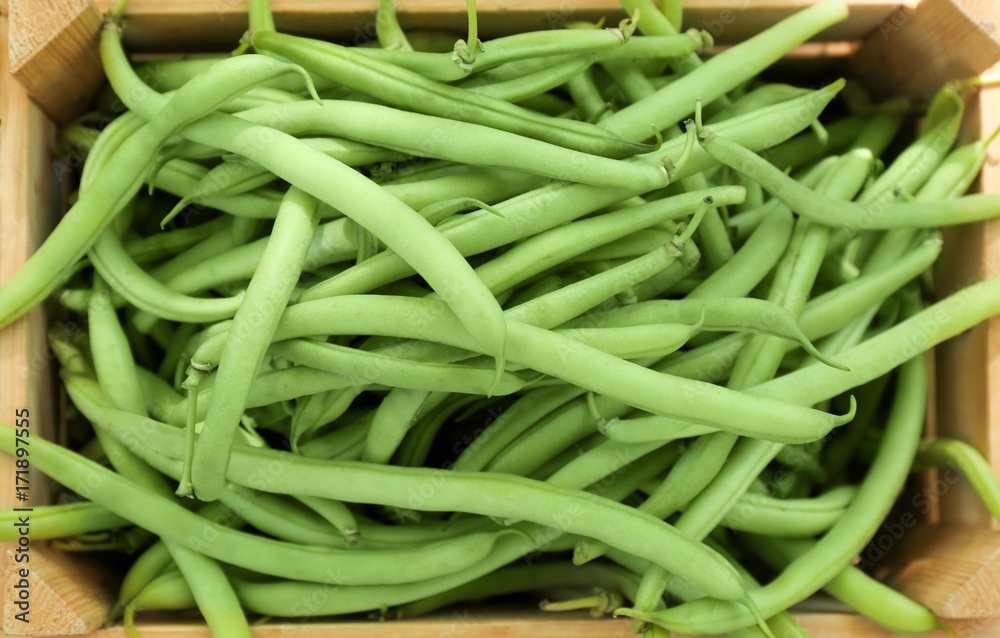 Raw fresh organic green beans in wooden crate, close up Raw fresh organic green beans in wooden crate, close up