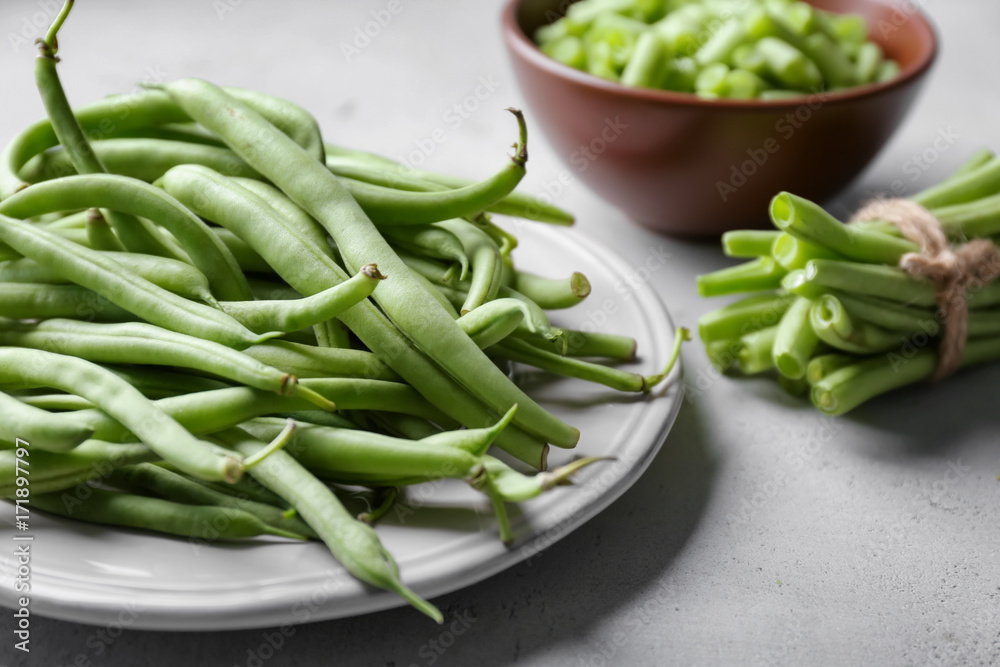 Plate with fresh green beans on table Plate with fresh green beans on table