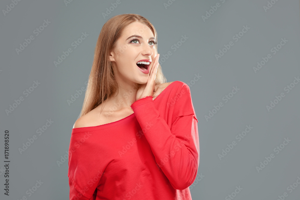 Beautiful young woman on grey background Beautiful young woman on grey background