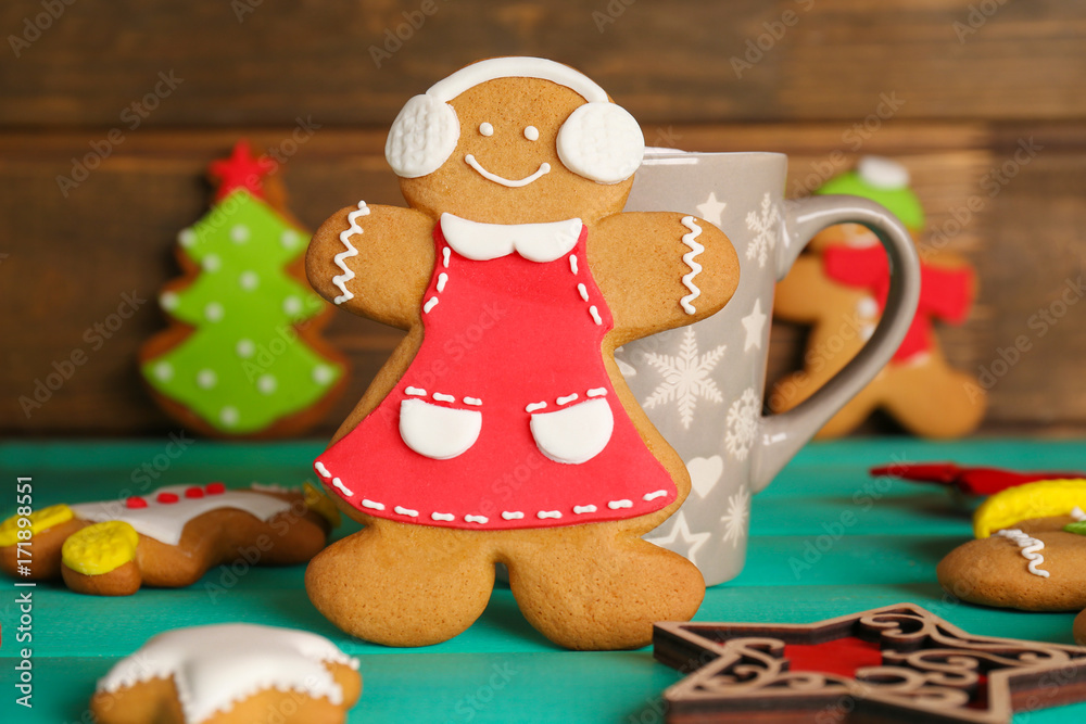 Tasty Christmas homemade cookies and cup on wooden background