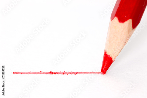 Close up red pencil with stroke isolated on white background
