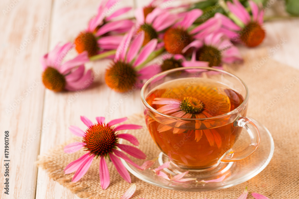 Cup of echinacea tea on white wooden table Cup of echinacea tea on white wooden table