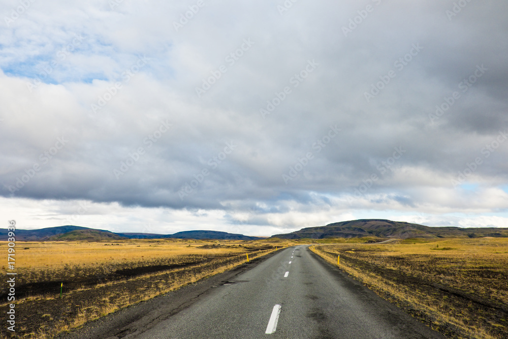 Empty road leading to mountains, Iceland