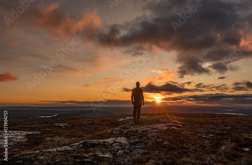 Man standing in scenic sunrise