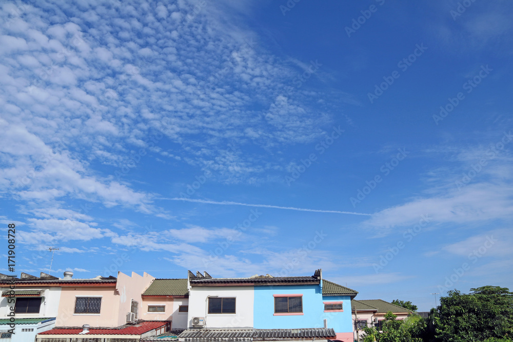 The white cloud and the line of Jet plane engine exhaust contrails forming on the blue sky. The beauty of clouds and the blue sky According to the imagination over the village. The white cloud and the line of Jet plane engine exhaust contrails forming on the blue sky. The beauty of clouds and the blue sky According to the imagination over the village.