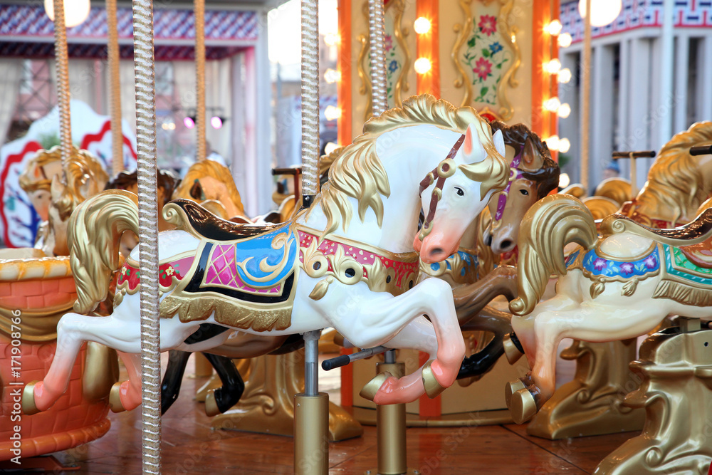 Children's carousel with horses at the festival