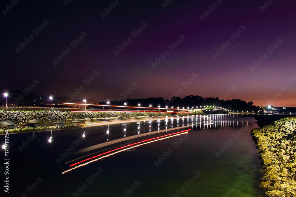 Night view of ferry lights arriving to Somo pier in Santander. Cantabria, Spain