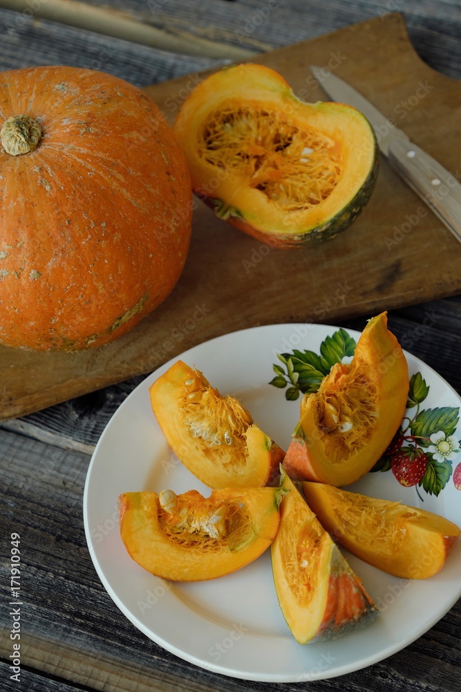 Delicious fresh orange pumpkin on wooden table 