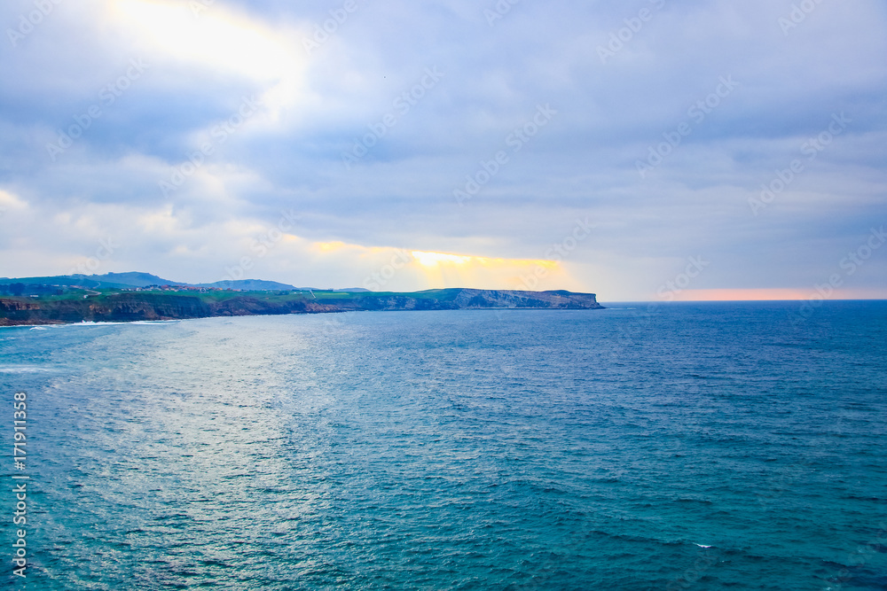 Cliffs of Suances at sunset , which stretches around the confluence of the rivers Saja and Besaya. It has excellent beaches, like that of Los Locos, which is ideal for surfing