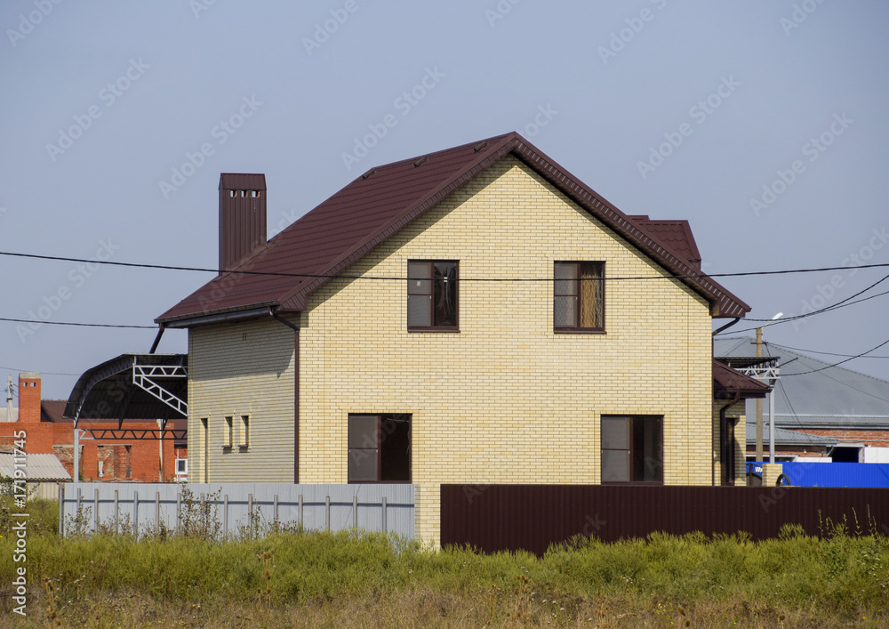 The house with plastic windows and a roof of corrugated sheet The house with plastic windows and a roof of corrugated sheet