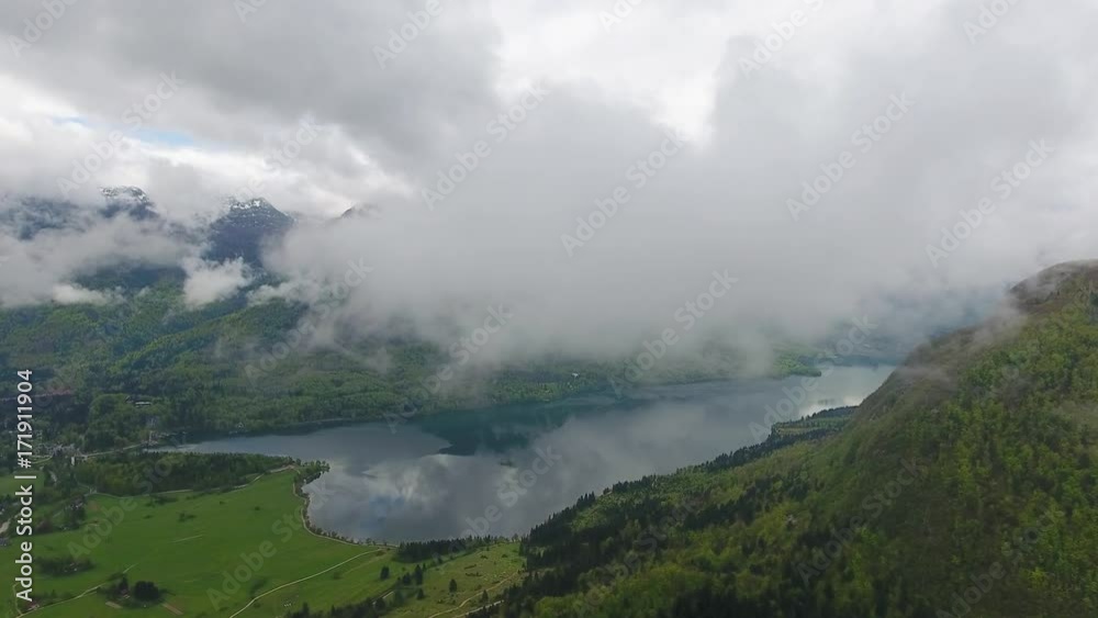 Aerial view on Bohinjsko jezero between mountains in Slovenia at spring, 4k
