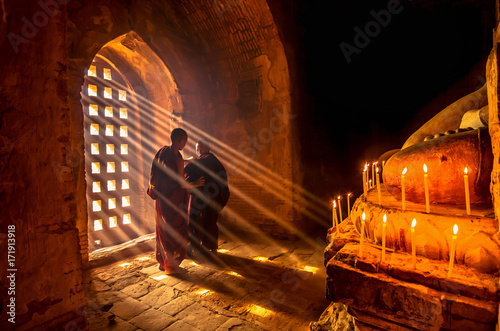 Obraz na płótnie Two asian Burmish monk change the robe with sun ray in pagoda at bagan, mandalay, myanmar w salonie