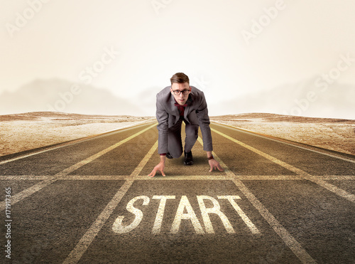 Businessman kneeling in ready position