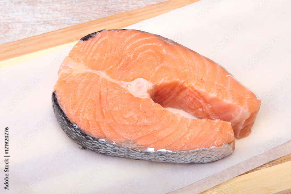 fresh raw salmon with spices on wooden cutting board. ready for cookin fresh raw salmon with spices on wooden cutting board. ready for cookin