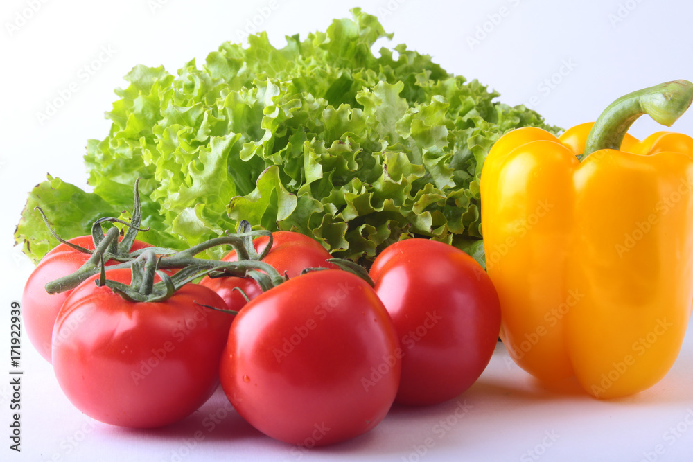 Fresh assorted vegetables bell pepper, tomato, garlic with leaf lettuce. Isolated on white background. Selective focus. Fresh assorted vegetables bell pepper, tomato, garlic with leaf lettuce. Isolated on white background. Selective focus.