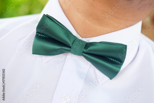 Green tie on a white shirt.