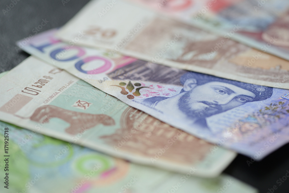 Some banknotes of Georgian lari on a dark background