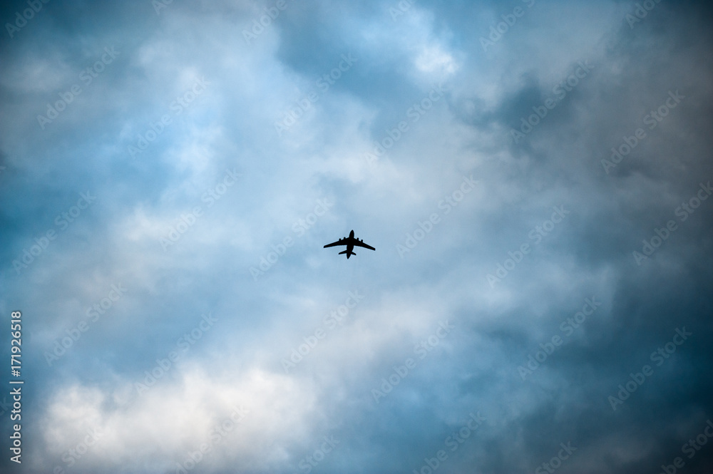 aircraft flying amongst storm clouds