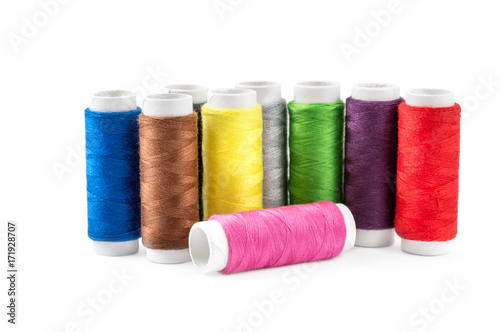 Colored sewing threads on white.