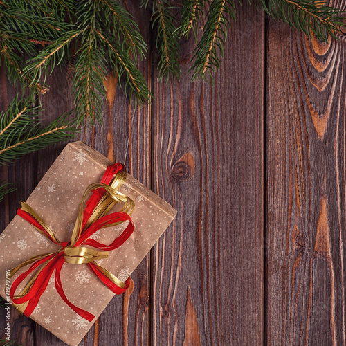 Christmas gift boxes and fir tree  on wooden background.