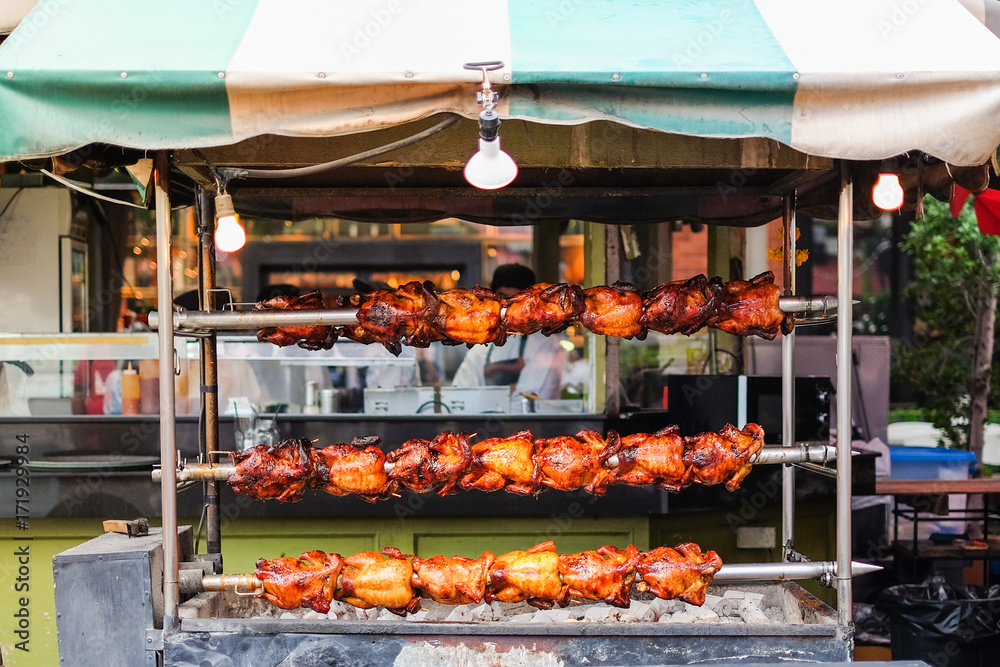 The homemade roasted chicken on skewers for street food background or texture.