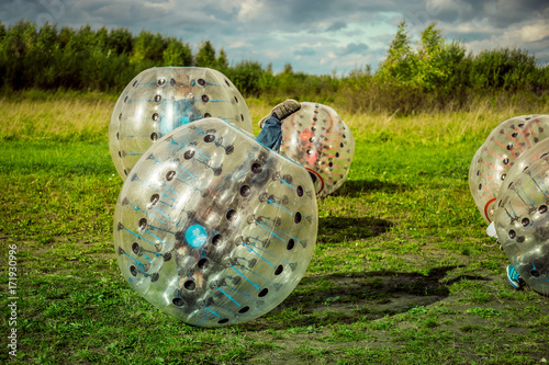 Bumperball. Teens play bumper-ball outdoor