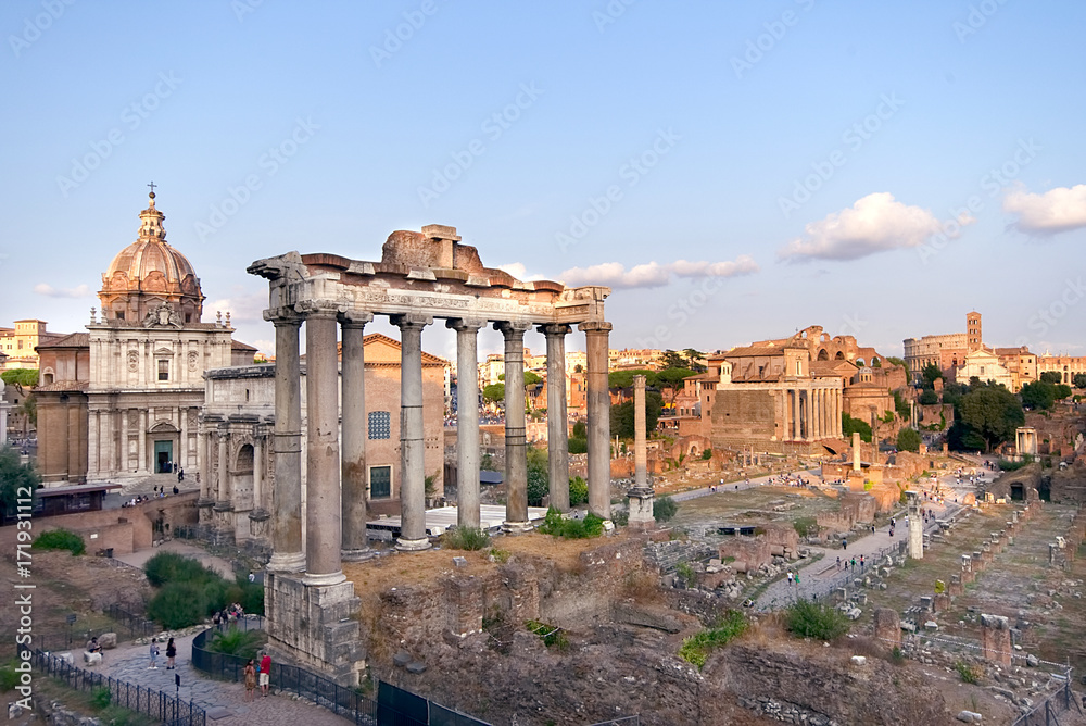 Rome, Italy. Ruins of the Roman Forum, with temple of Saturn, at sunset. Famous historical landmark in Europe.
