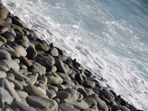 Background from sea stones and sea. Structure. Stone floor texture.