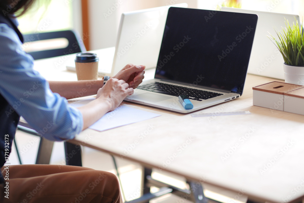 Young woman sitting at office table with laptop. Young woman. Laptop Young woman sitting at office table with laptop. Young woman. Laptop