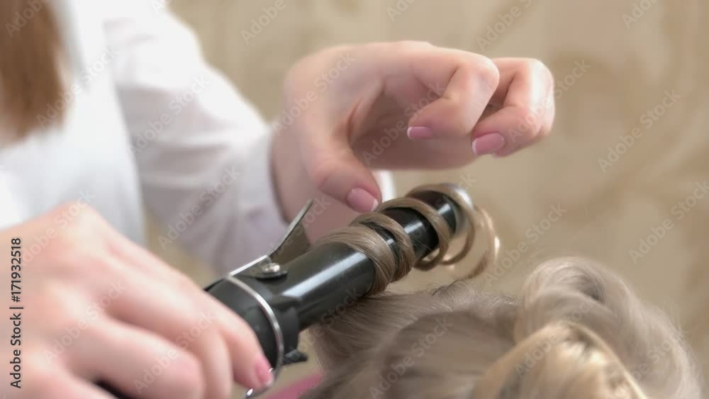 Blonde hair and curling iron. Hair styling tool, close up. Buy curling iron online.