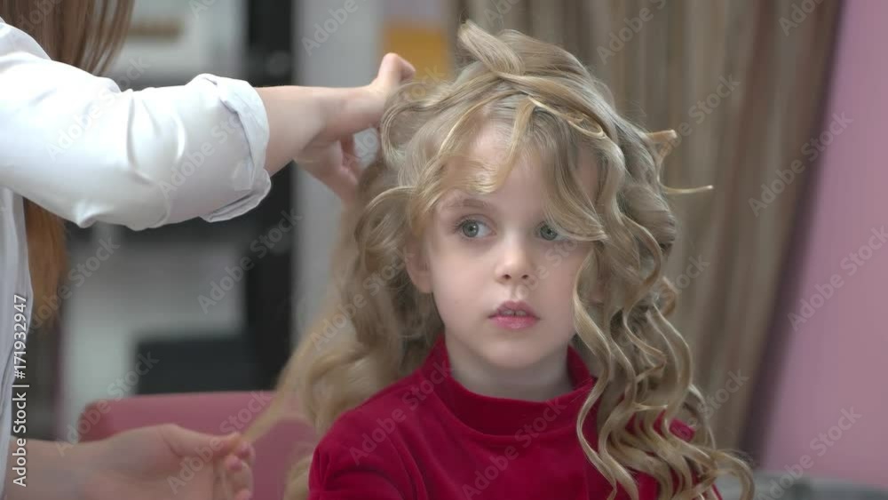 Little girl with curly hair. Kid at the hairdresser. Little girl with curly hair. Kid at the hairdresser.