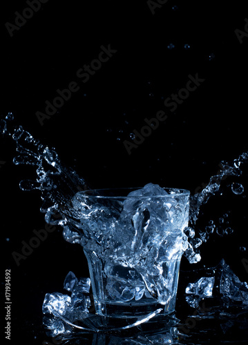ice cube drops into water