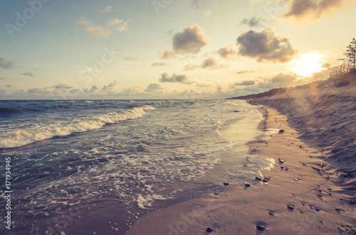 Sunrise over sandy beach and cliffs on Baltic sea coast  Poland  Rowy