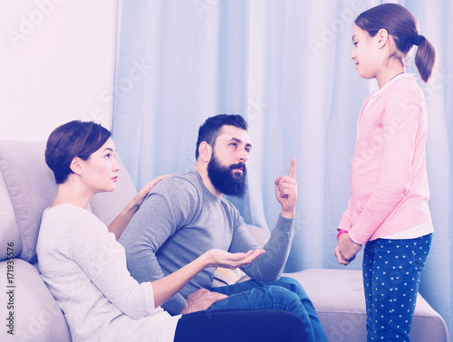 Parents lecturing their daughter